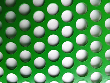 A piece of round hole perforated sheet in green color.