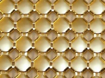 A piece of gold color metallic fabric with uniform structure.