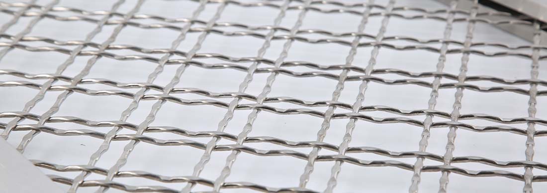 A piece of stainless steel architectural woven mesh.
