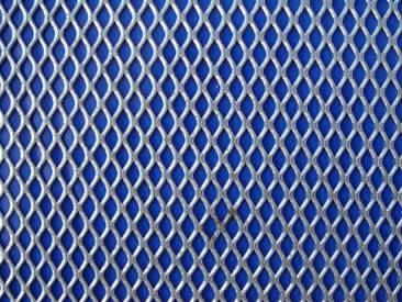 A piece of architectural expanded mesh with fan-shaped hole.