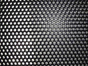 Black perforated sheet metal with round holes and shiny surface.