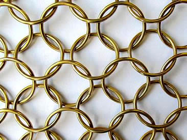 A piece of architectural ring mesh is connected ring by ring.