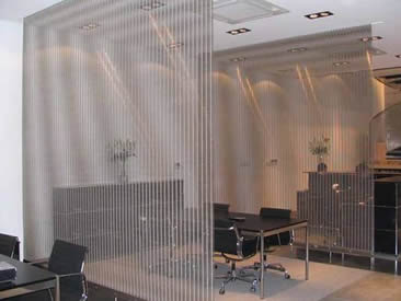 Two architectural cable mesh are used in office as space divider.
